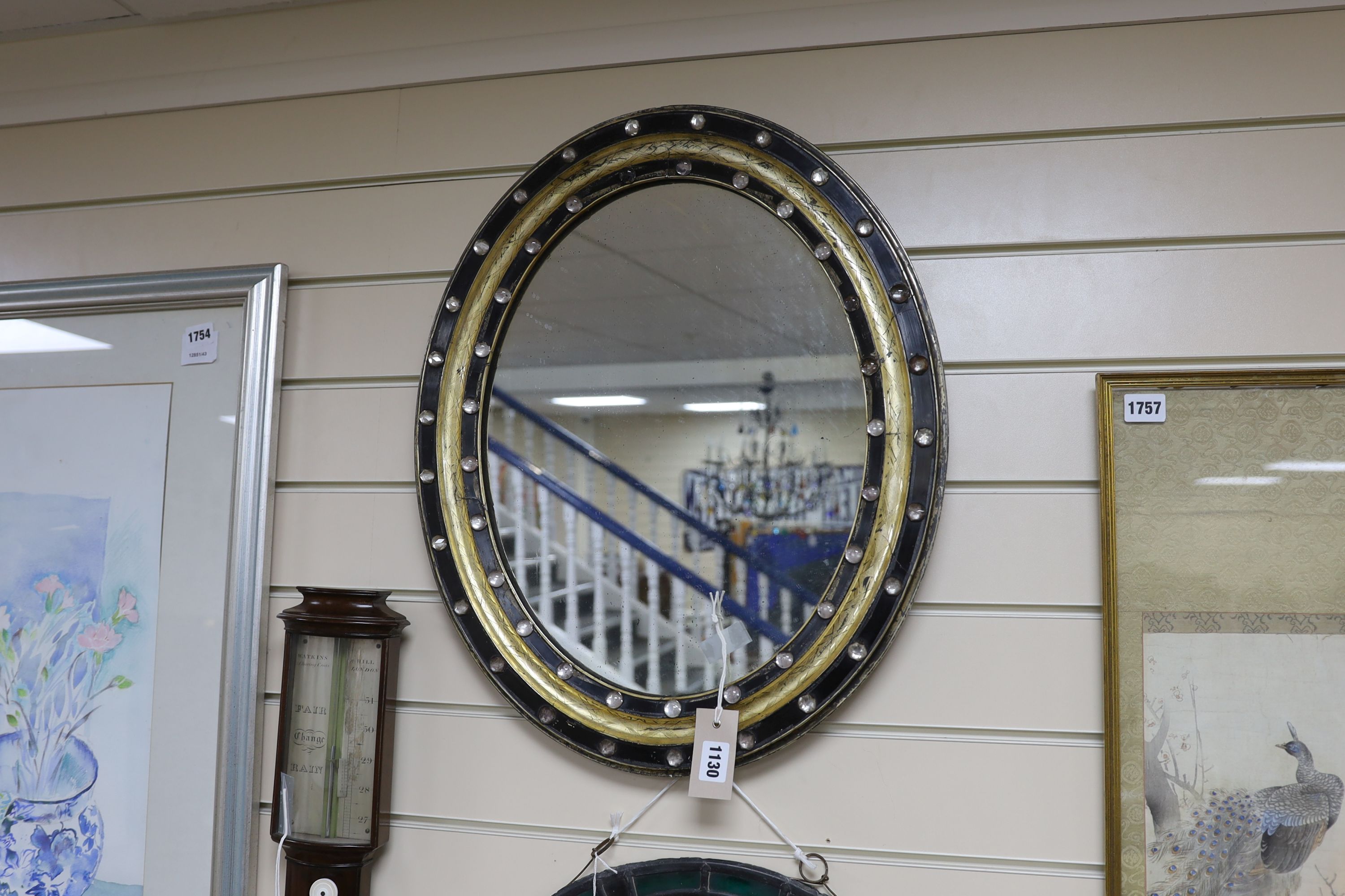 A small 19th century Irish oval wall mirror, with twin faceted and cabochon glass border, width 46cm, height 56cm